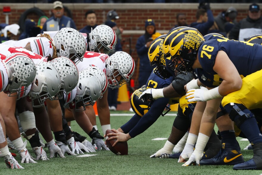 Ohio State and Michigan lined up at the line of scrimmage during Week 14 Rivalry Week game, used for college football picks and predictions.